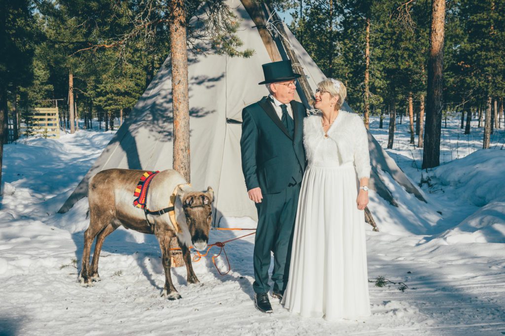 Couple meets and greets the reindeer before their wedding ceremony.